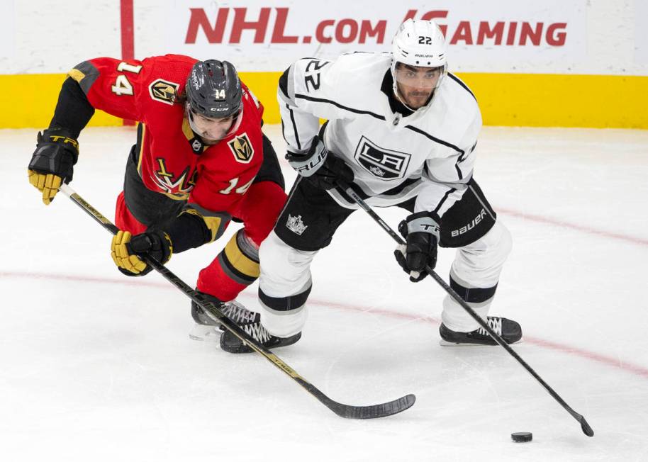 Golden Knights defenseman Nicolas Hague (14) and Kings left wing Andreas Athanasiou (22) compet ...