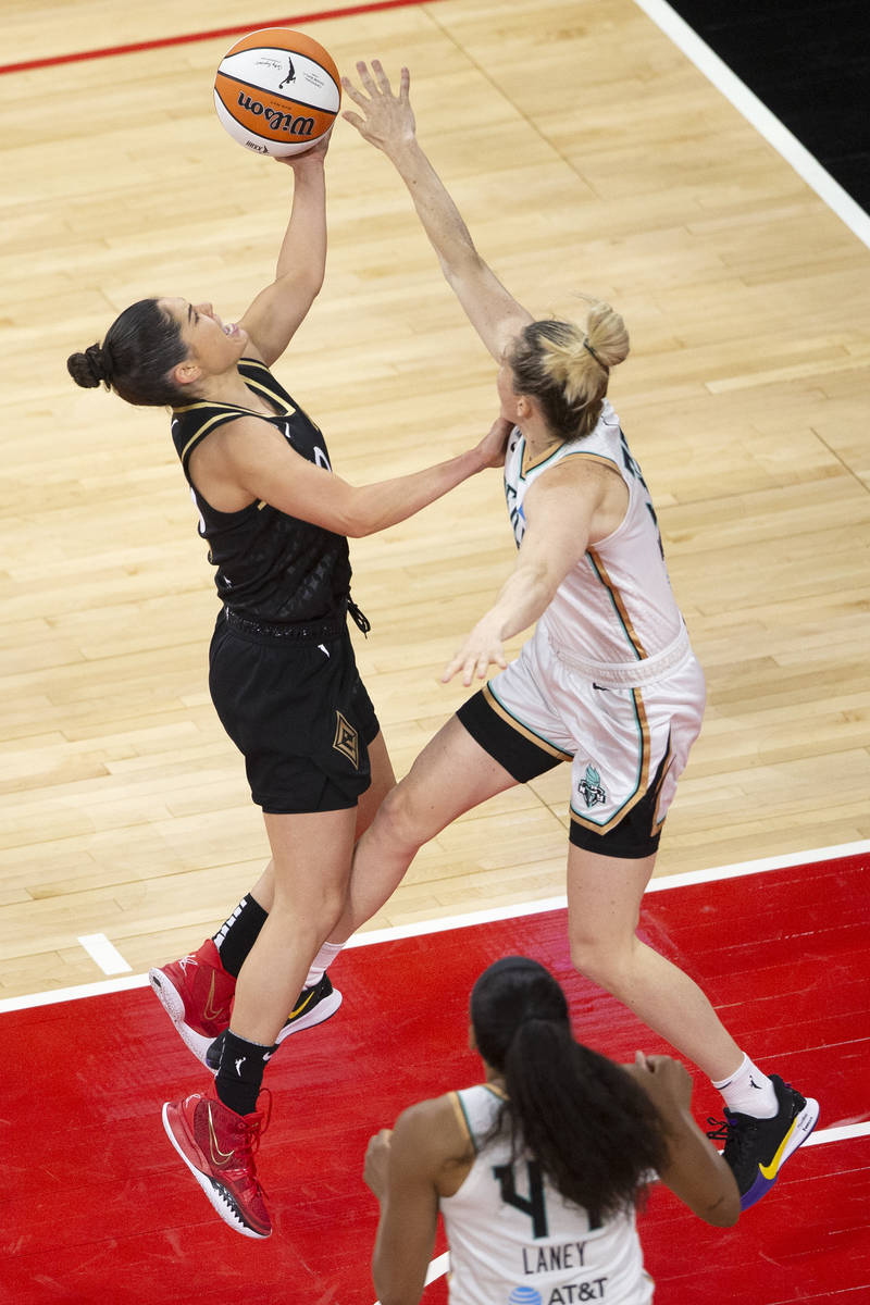Las Vegas Aces guard Kelsey Plum (10) shoots a point while New York Liberty guard Sami Whitcomb ...