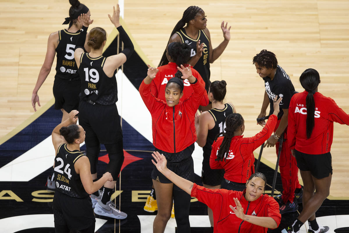 The Las Vegas Aces, including forward A'ja Wilson (22), center, and center Liz Cambage (8), bot ...