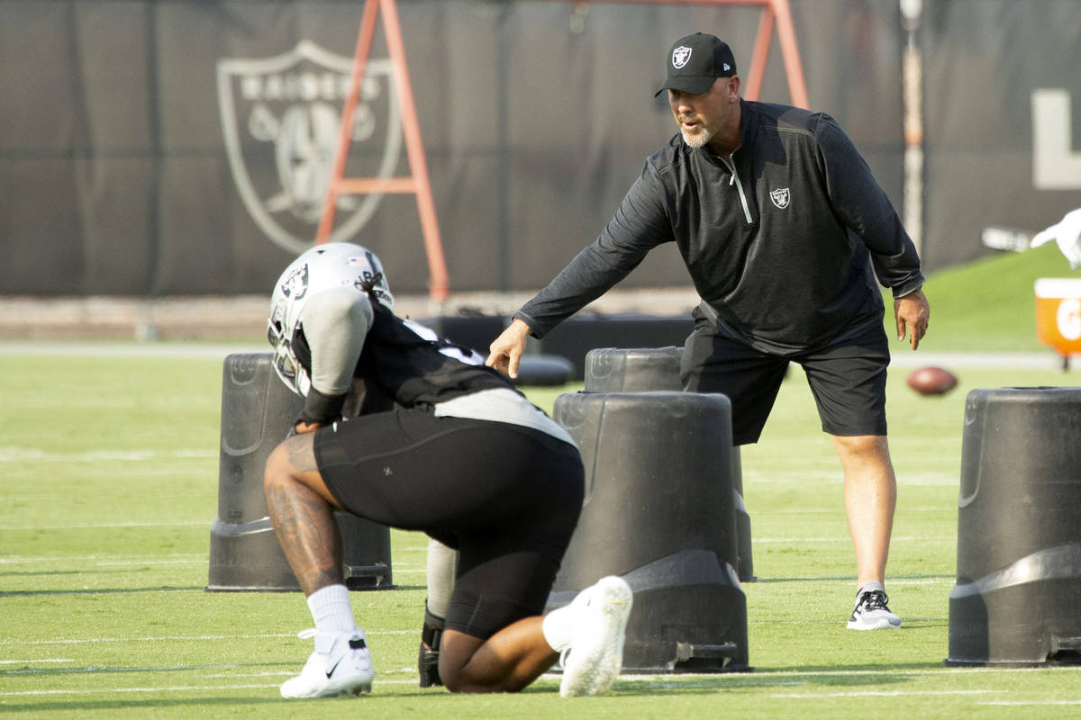 Raiders defensive coordinator Gus Bradley instructs defensive end Kendal Vickers (91) during th ...