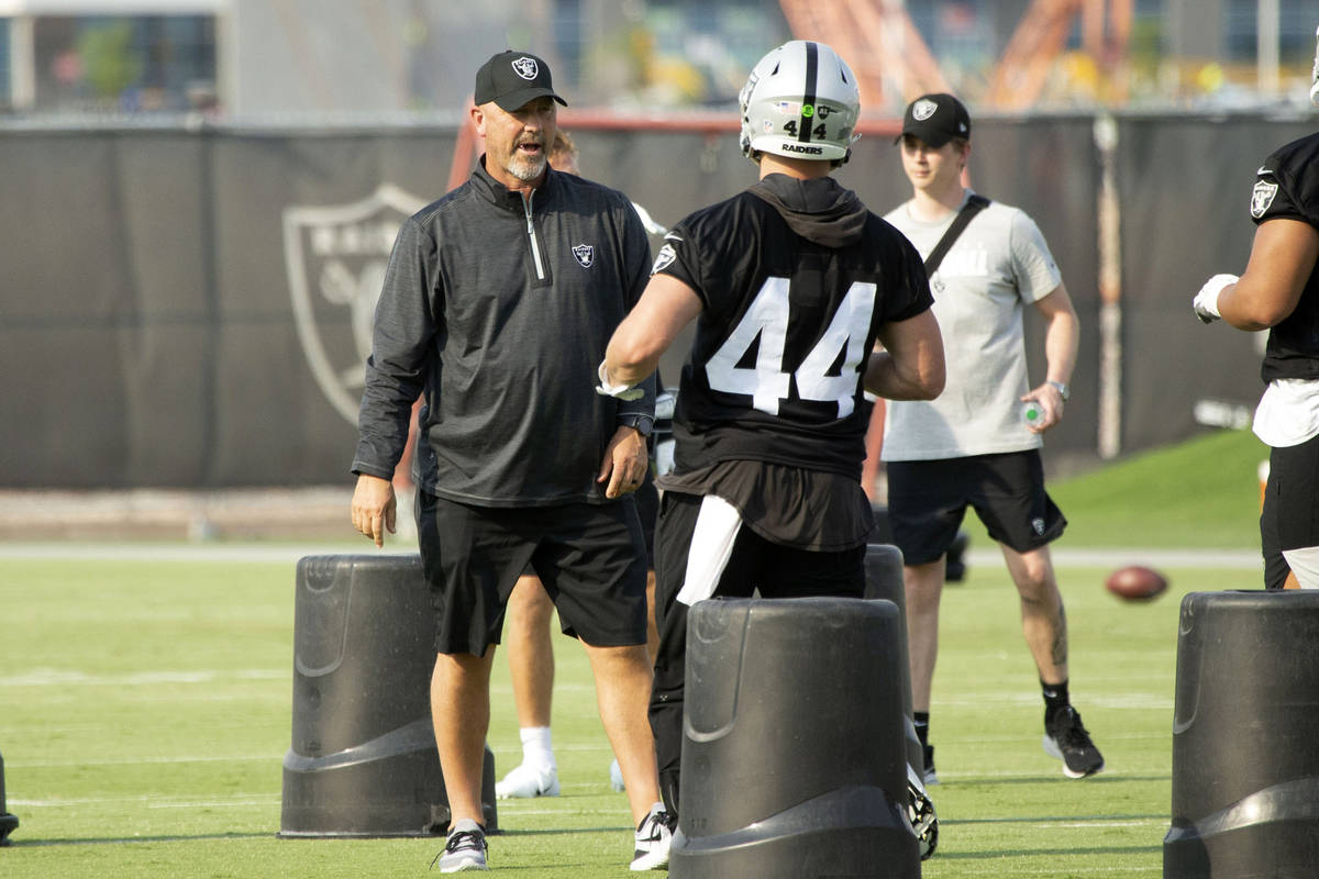 Raiders defensive coordinator Gus Bradley speaks with linebacker Nick Kwiatkoski (44) during th ...