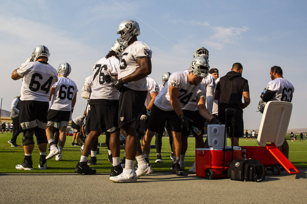 Raiders players hydrate during an NFL football minicamp at Raiders headquarters in Henderson on ...