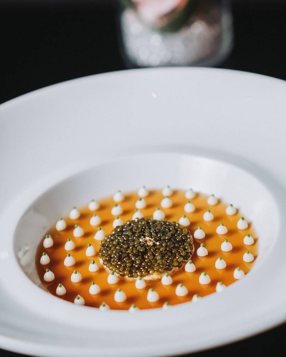 Ossetra caviar served atop king crab in a crustacean gelée dotted with cauliflower puree at Jo ...