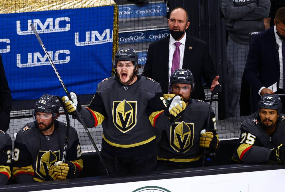 Golden Knights' Mattias Janmark, center, and head coach Pete DeBoer react to a call during the ...