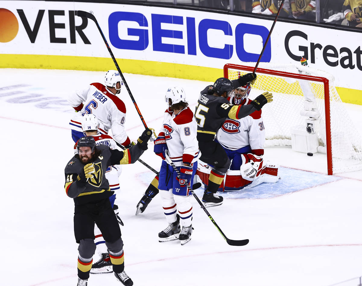 Golden Knights' Mark Stone (61) and Keegan Kolesar (55) celebrate after a goal by defenseman Al ...