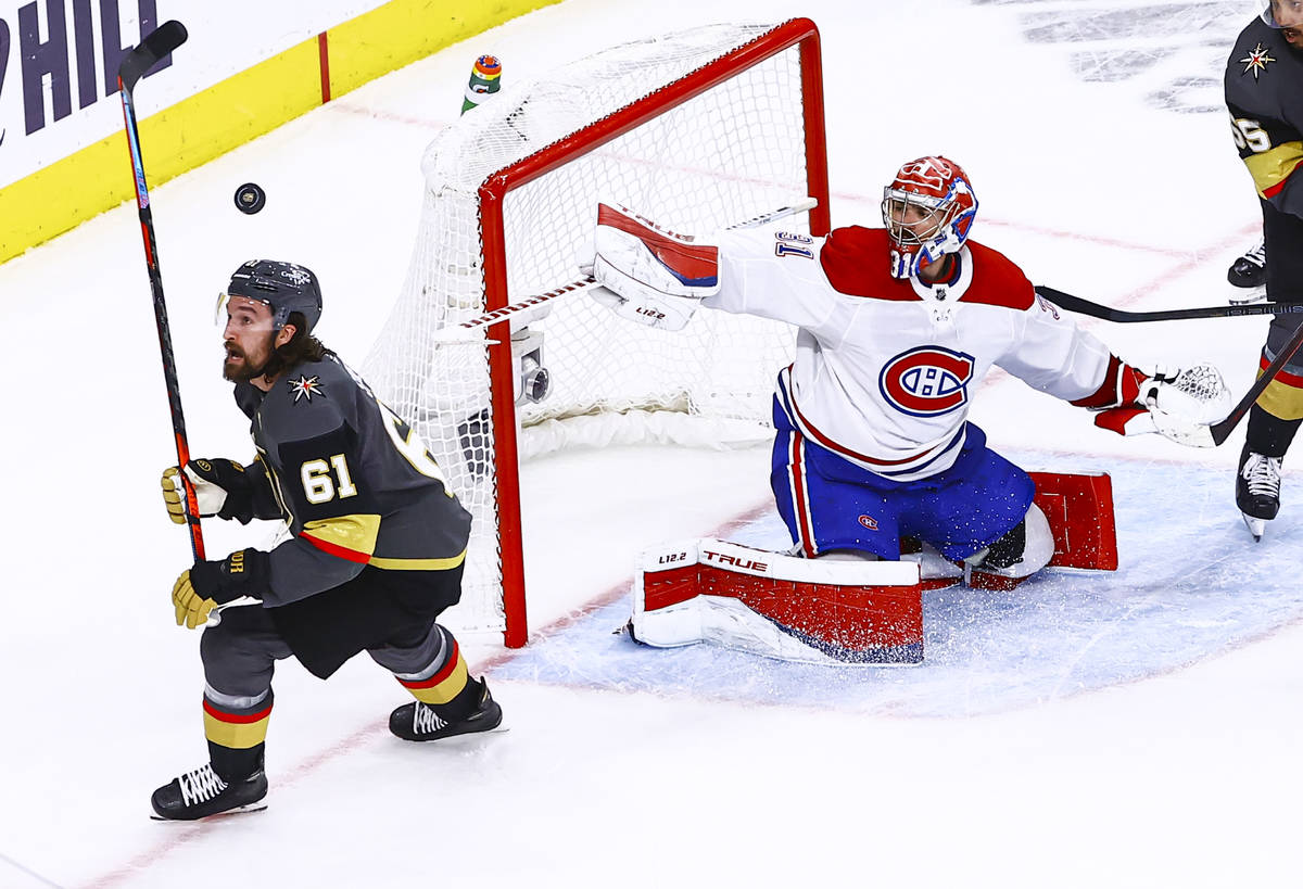 The puck flies over Golden Knights' Mark Stone (61) as Montreal Canadiens goaltender Carey Pric ...