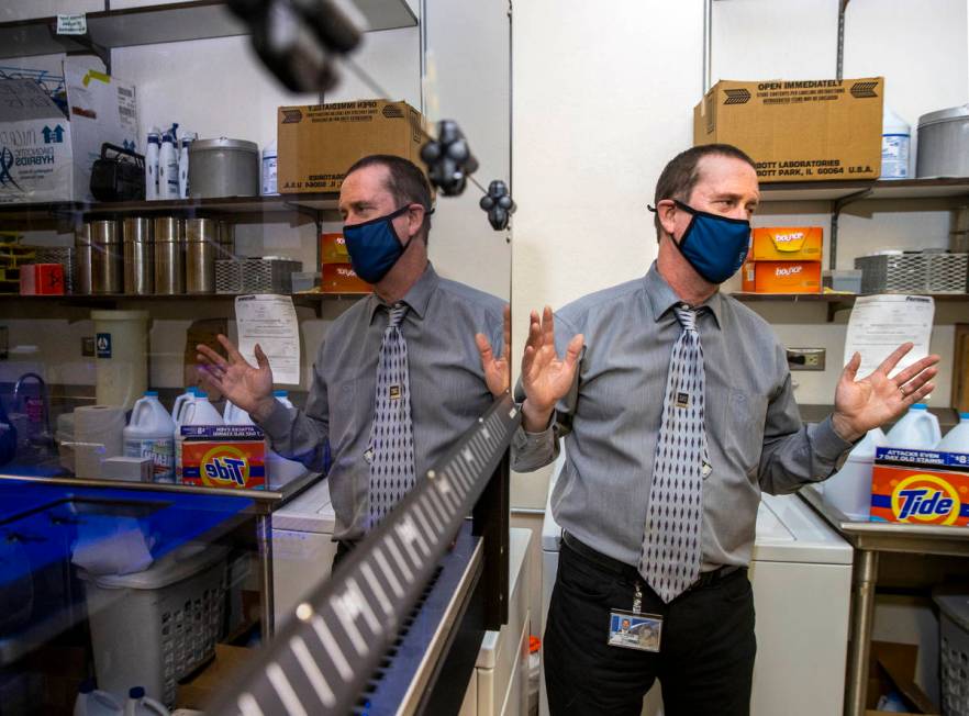 Dr. Mark Pandori, Director of the Nevada State Public Health Lab, with one of their automated g ...