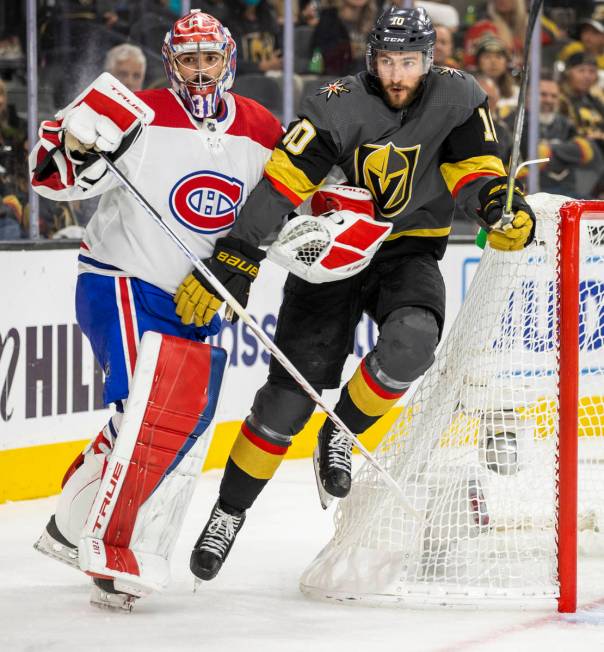 Golden Knights center Nicolas Roy (10) fights for position with Montreal Canadiens goaltender C ...
