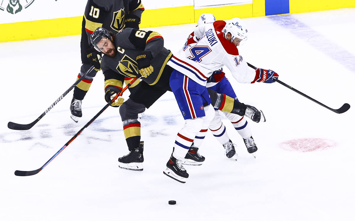 Golden Knights' Mark Stone (61) and Montreal Canadiens' Nick Suzuki (14) get tripped up during ...