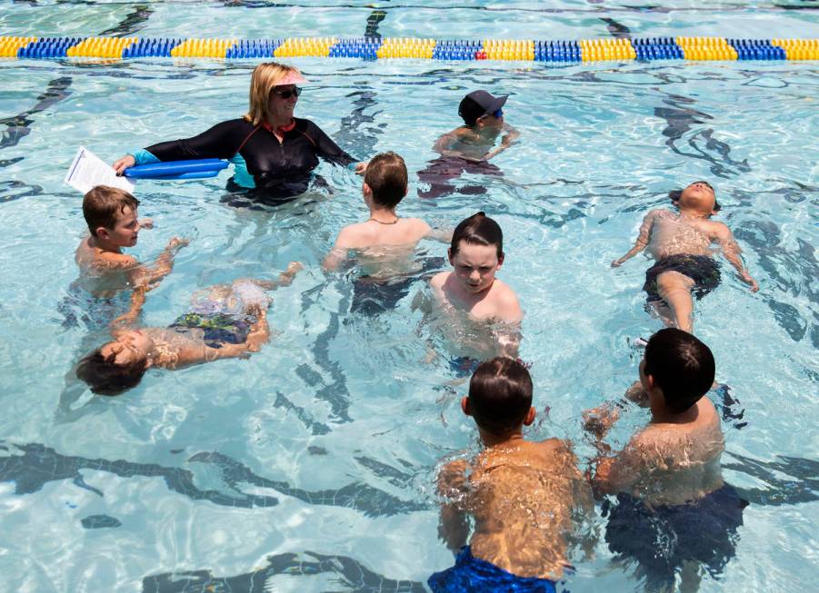 Kim Tyler, a volunteer instructor, watches as children swim during the 12th annual World&#x2019 ...