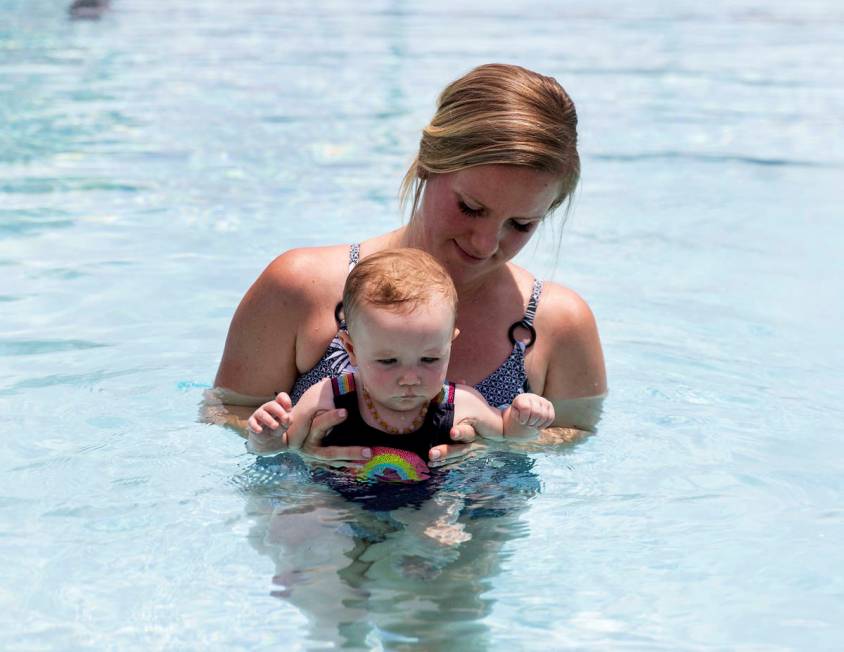 Taylor Speight gives swimming lesson to her seven-month-old daughter Stevie at Boulder City Swi ...