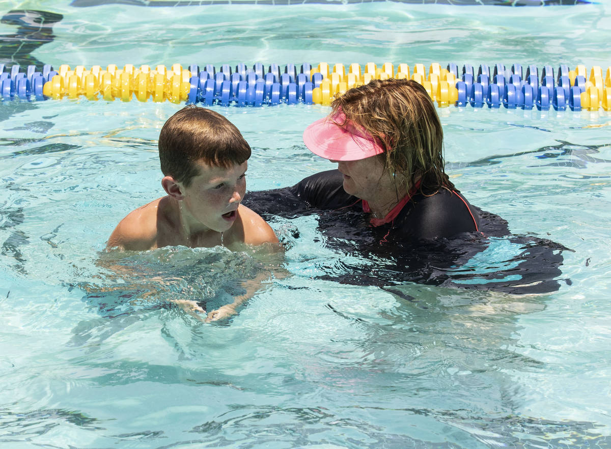 Kim Tyler, a volunteer instructor, helps Colbe Boyle, 10, during the 12th annual World's Larges ...