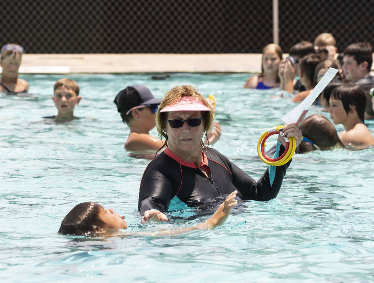 Kim Tyler, a volunteer instructor, watches as children swim during the 12th annual World's Larg ...