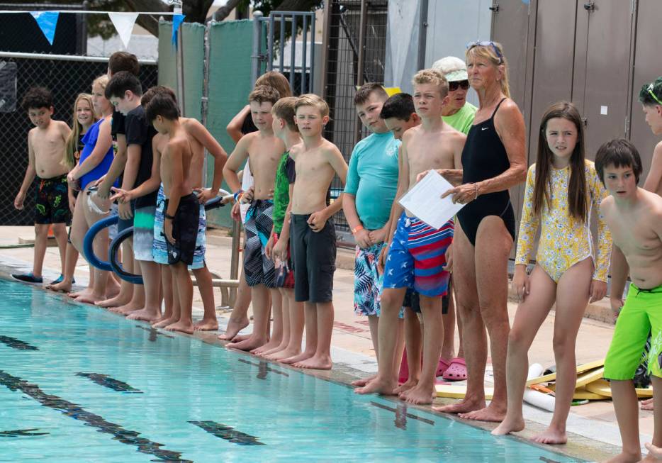 Children gather around the swimming pool during the 12th annual World's Largest Swimming Lesson ...
