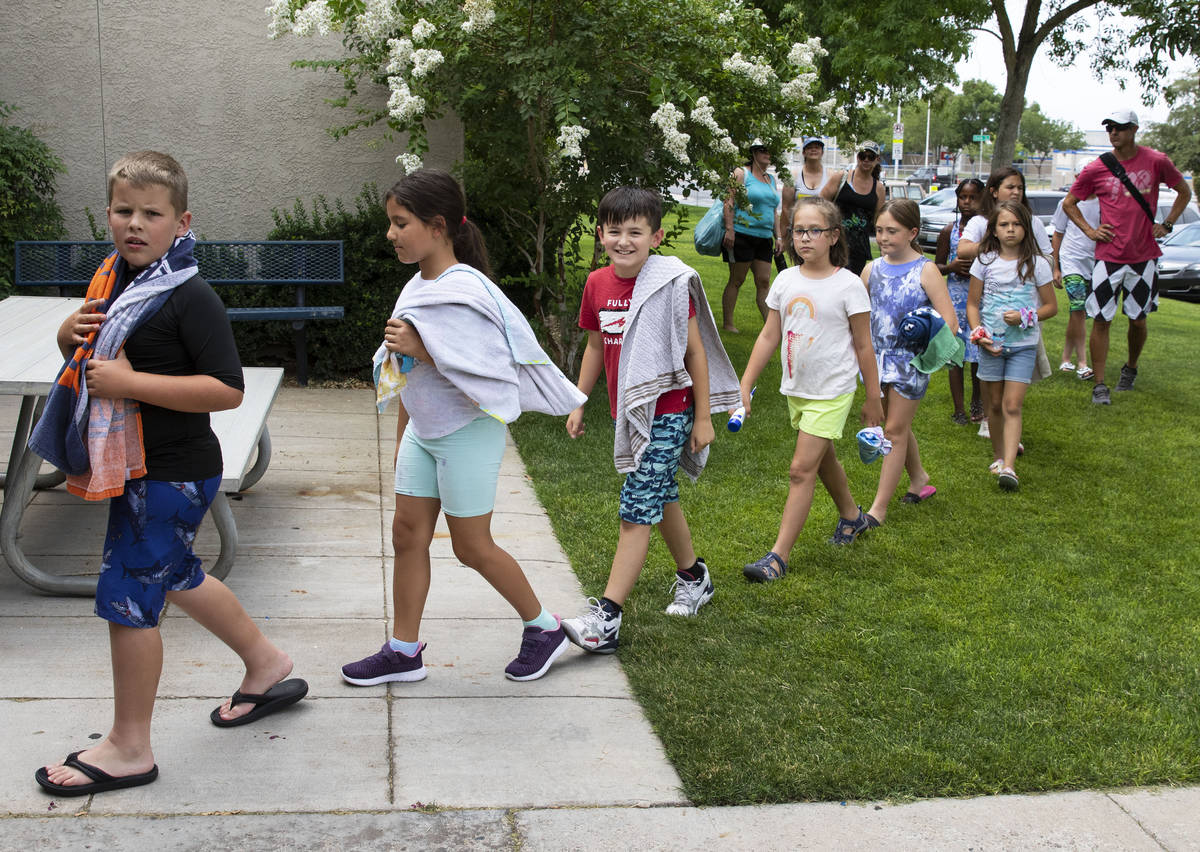 Children arrive to participate in the 12th annual World's Largest Swimming Lesson at Boulder Ci ...