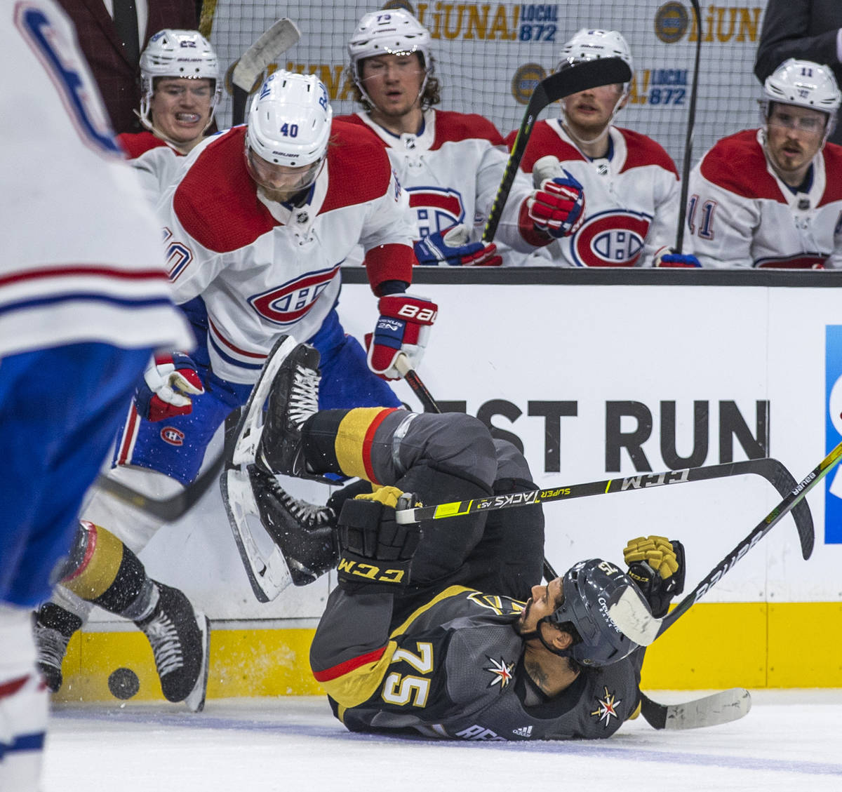 Golden Knights right wing Ryan Reaves (75) is taken to the ice while fighting for the puck with ...