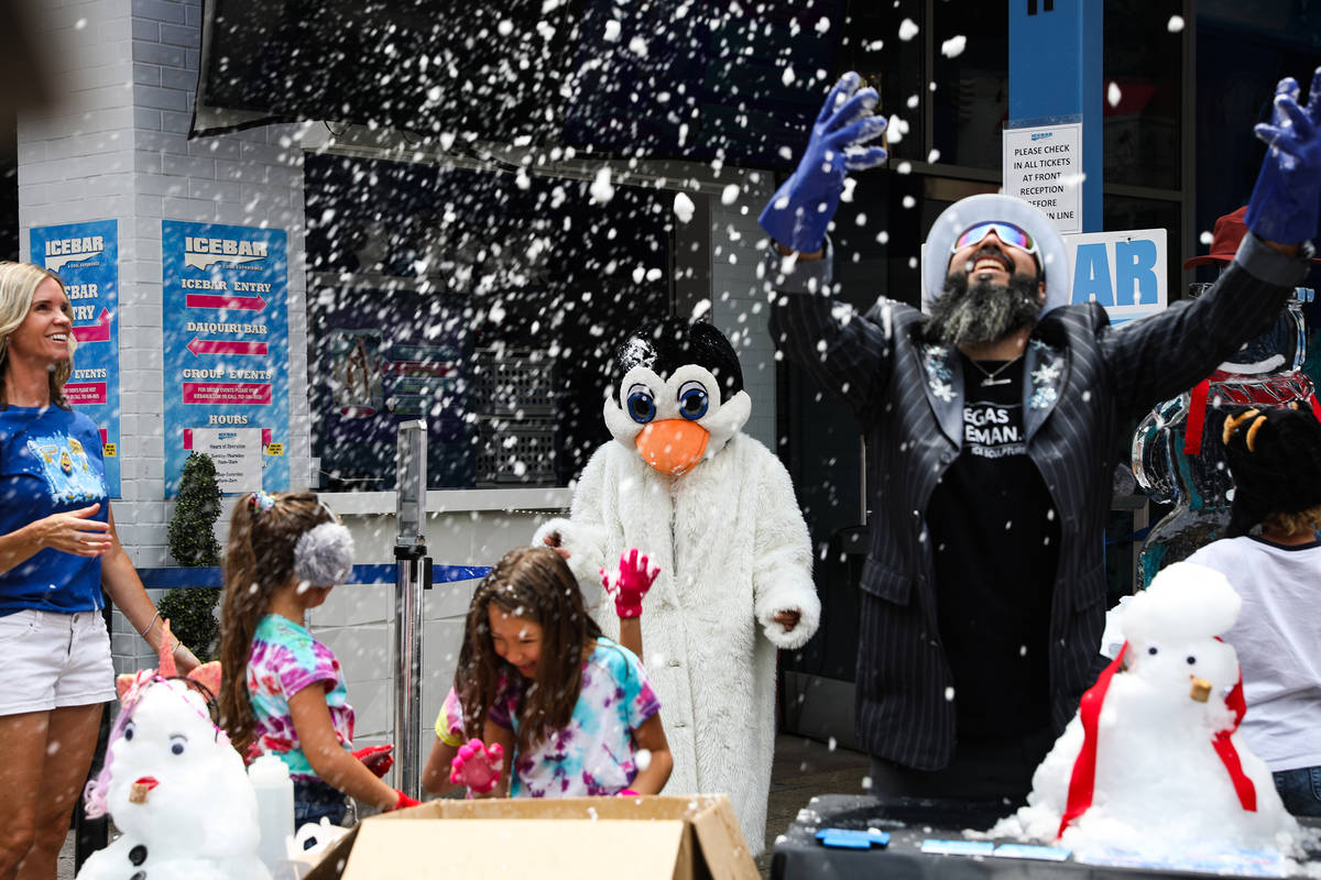Marco Villarreal, known as "Vegas Ice Man," throws snow in the air at an event to promote the I ...