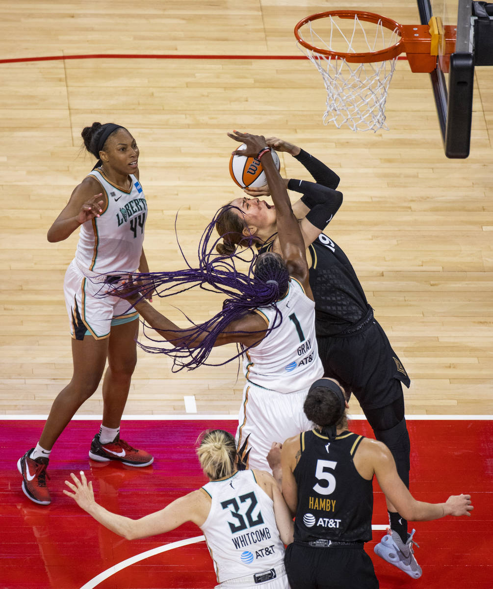 Las Vegas Aces center JiSu Park (19) gets off a shot while fouled by New York Liberty forward R ...