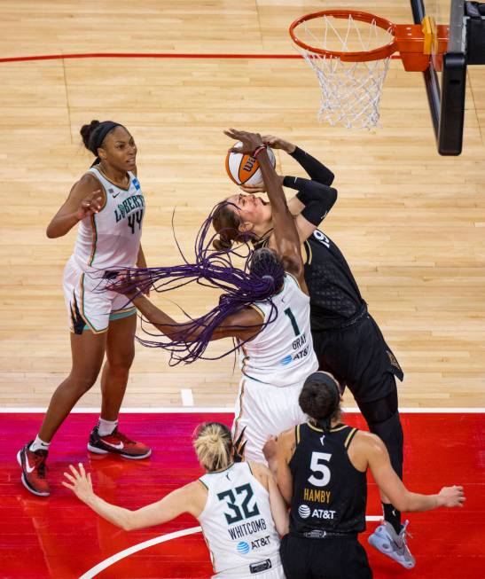 Las Vegas Aces center JiSu Park (19) gets off a shot while fouled by New York Liberty forward R ...