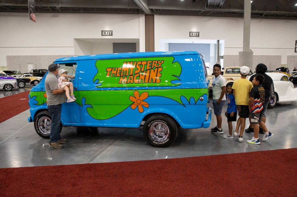 People check out the 1968 For Ecoline "Mystery Machine" van in the Barrett-Jackson au ...
