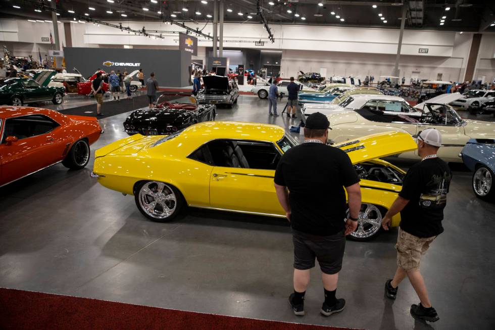 People check out cars showcased in the Barrett-Jackson auction at the Las Vegas Convention Cent ...