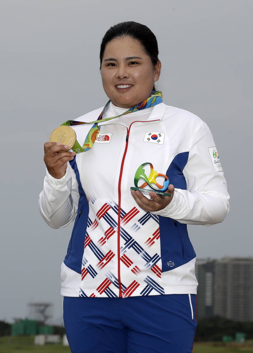 Inbee Park of South Korea, holds up her gold medal after the final round of the women's golf ev ...