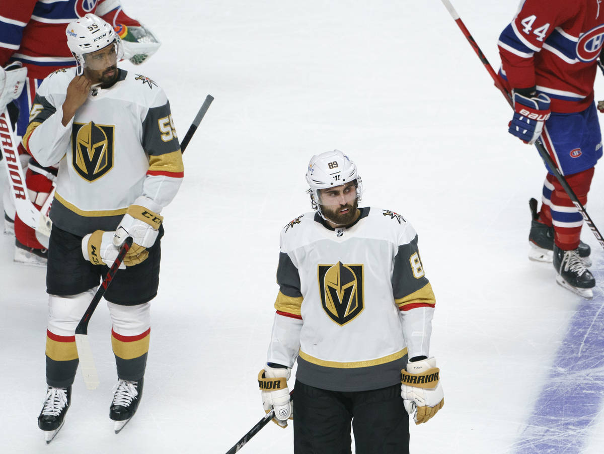 Vegas Golden Knights' Keegan Kolesar, left, and Alex Tuch skate off the ice after the team's lo ...