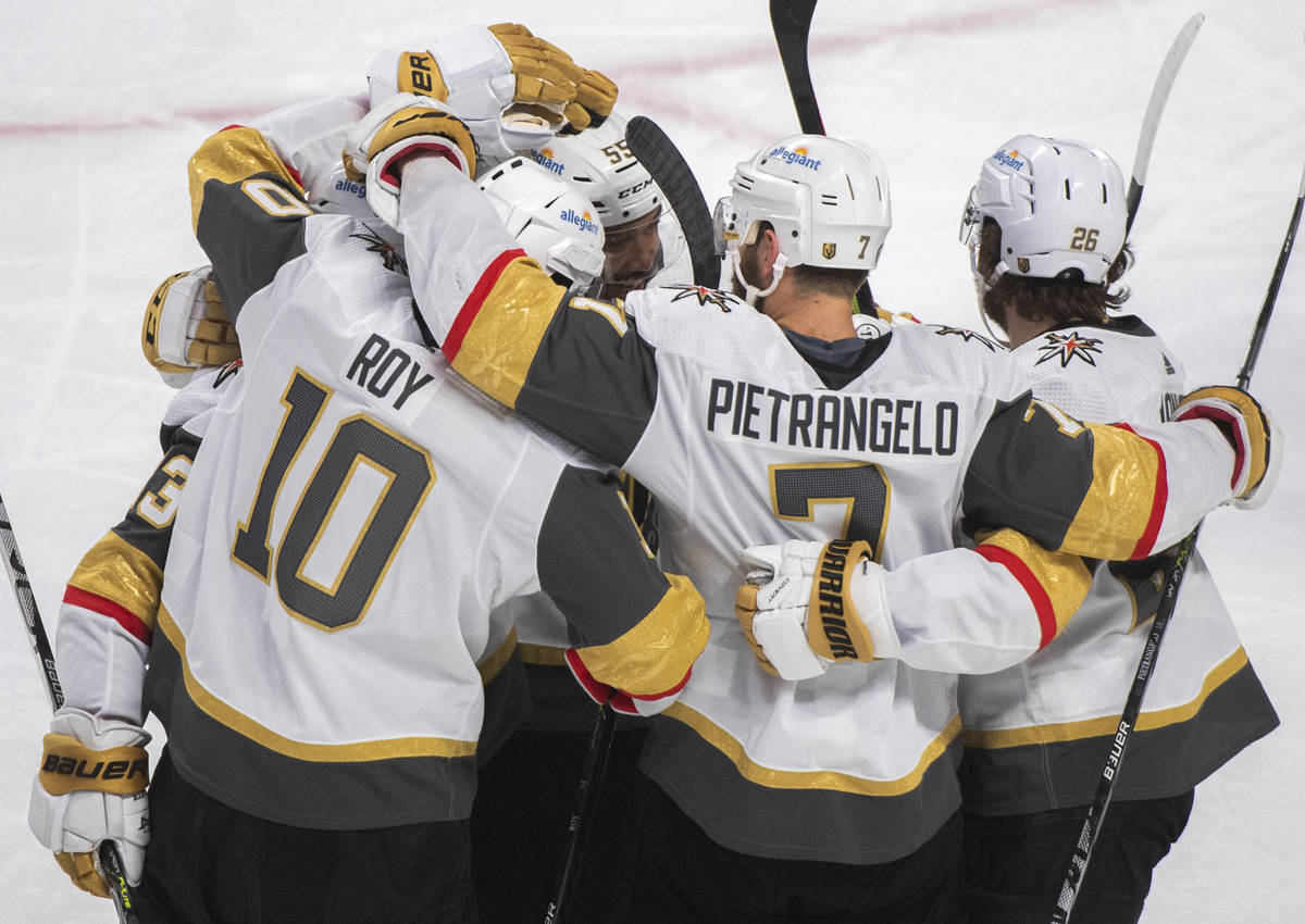 Vegas Golden Knights' Nicolas Roy (10) celebrates with teammates after scoring against the Mont ...