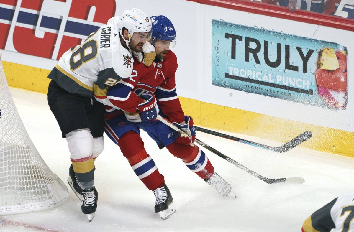 Vegas Golden Knights' William Carrier hangs on to Montreal Canadiens' Erik Gustafsson during th ...