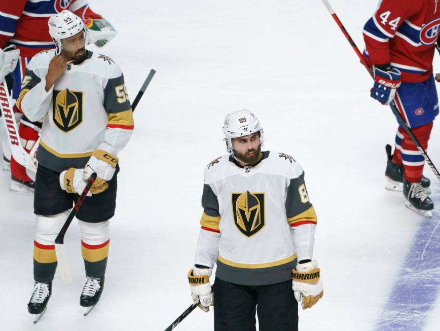 Vegas Golden Knights' Keegan Kolesar, left, and Alex Tuch skate off the ice after the team's lo ...