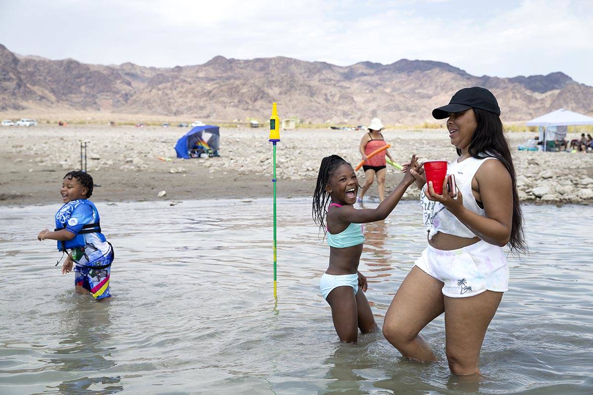 Damisha Simril, right, high-fives her daughter Jaki Walker, 8, after she made her mark in a gam ...