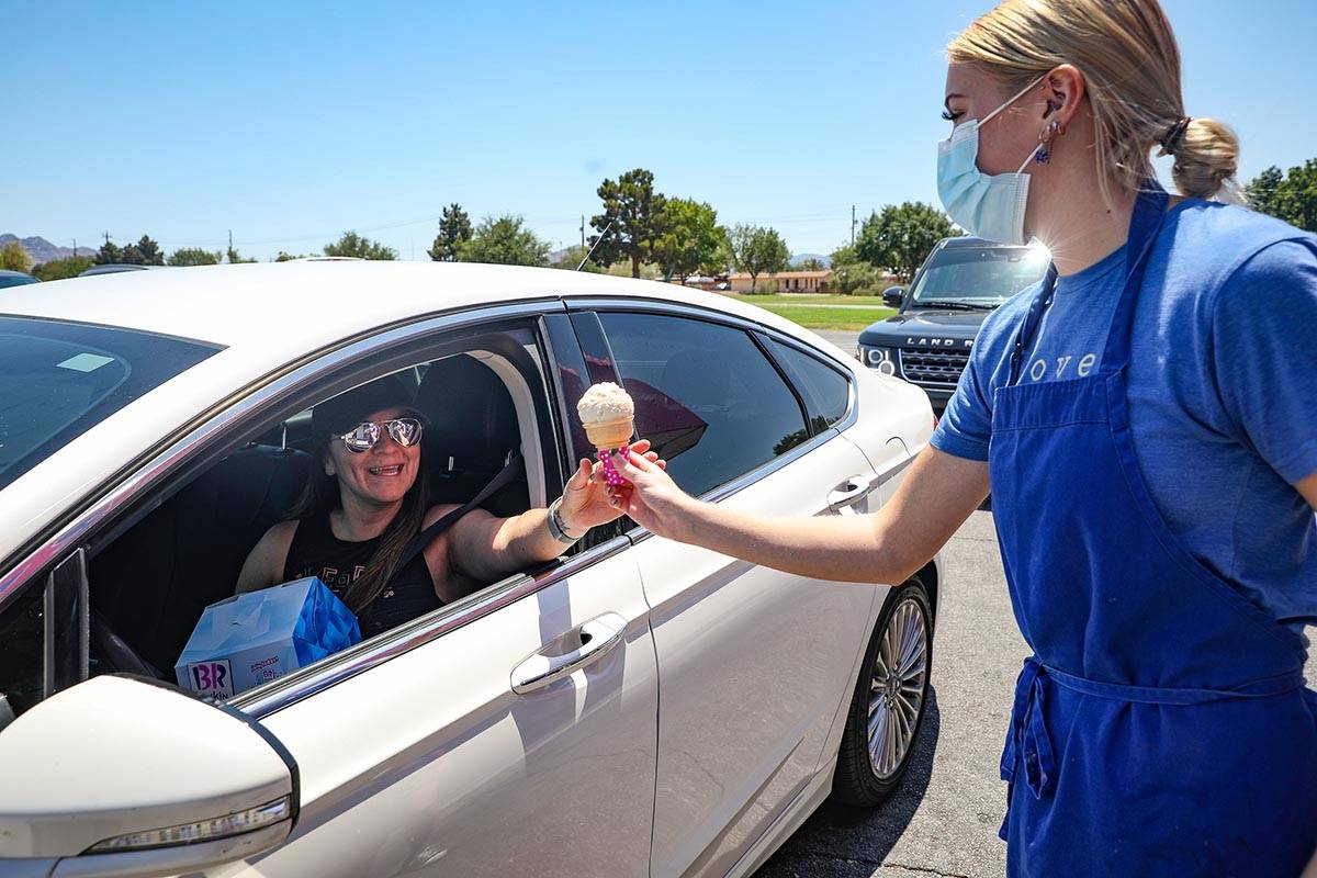 Grace Sanchez hands an ice cream to Danielle Pellinger outside Baskin Robbins in Henderson, Sun ...