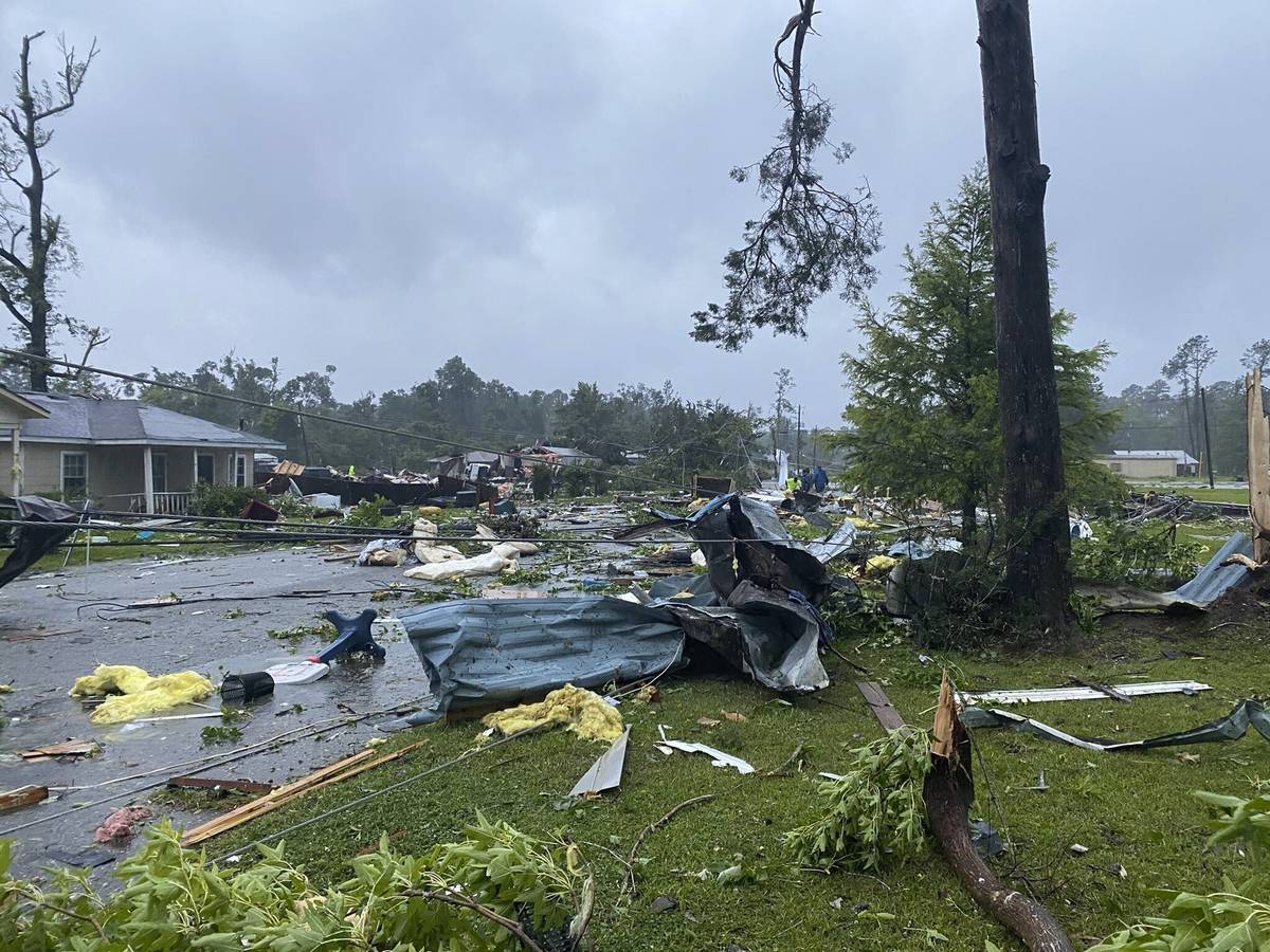 This photo provided by Alicia Jossey shows debris covering the street in East Brewton, Ala., on ...