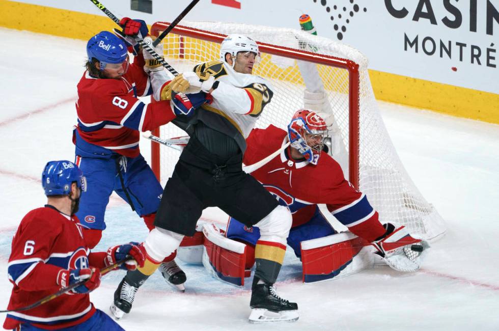 Vegas Golden Knights' Max Pacioretty is taken out by Montreal Canadiens defenseman Ben Chiarot ...