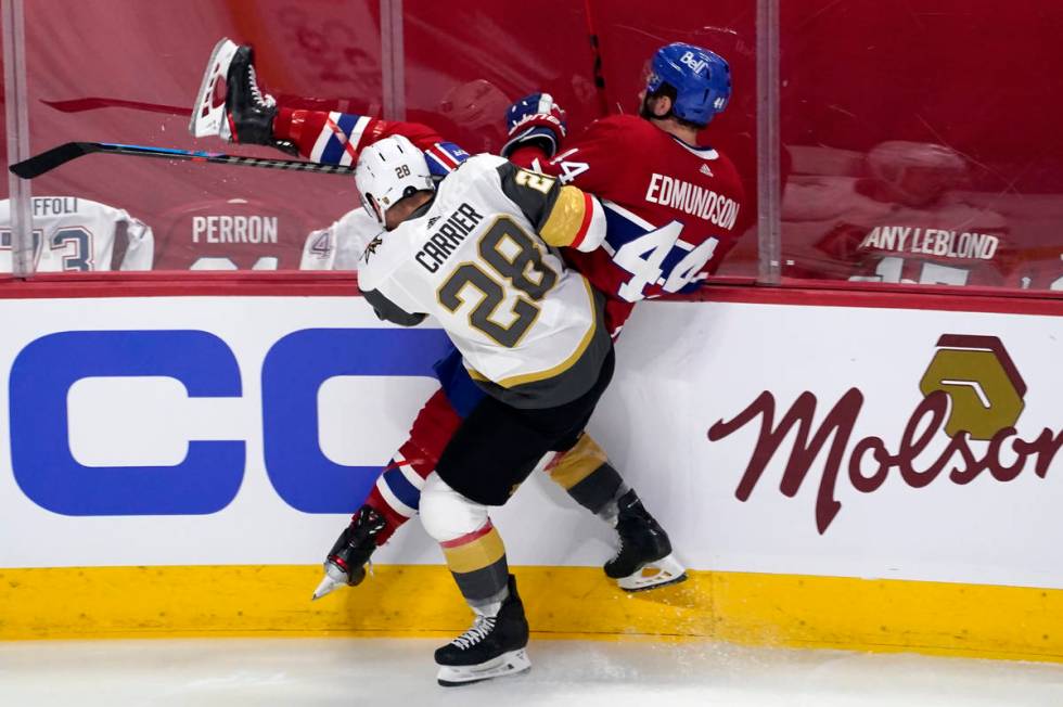 Vegas Golden Knights' William Carrier (28) checks Montreal Canadiens' Joel Edmundson (44) durin ...