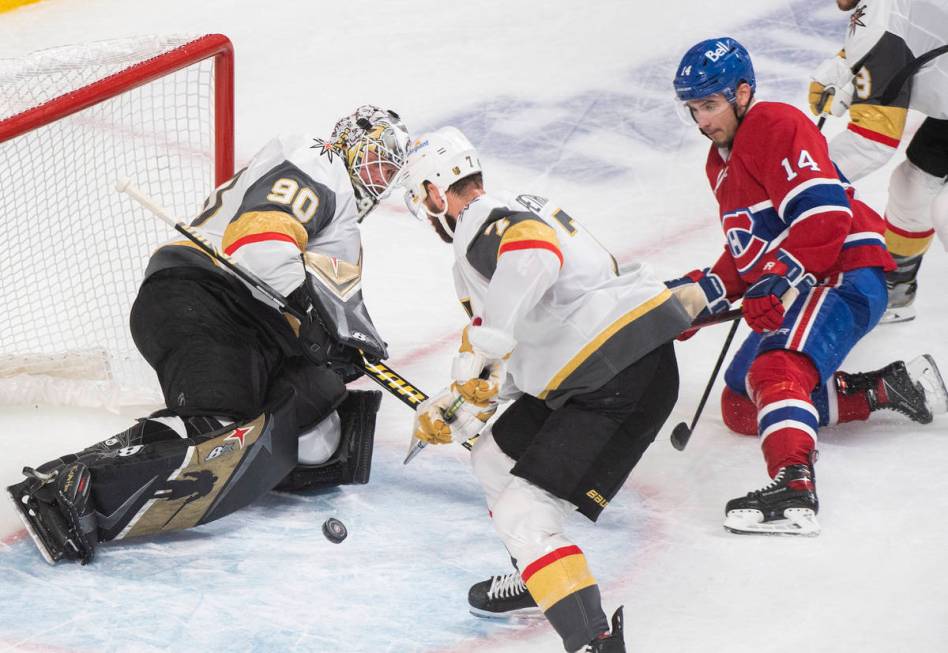Montreal Canadiens' Nick Suzuki (14) moves in on Vegas Golden Knights goaltender Robin Lehner a ...