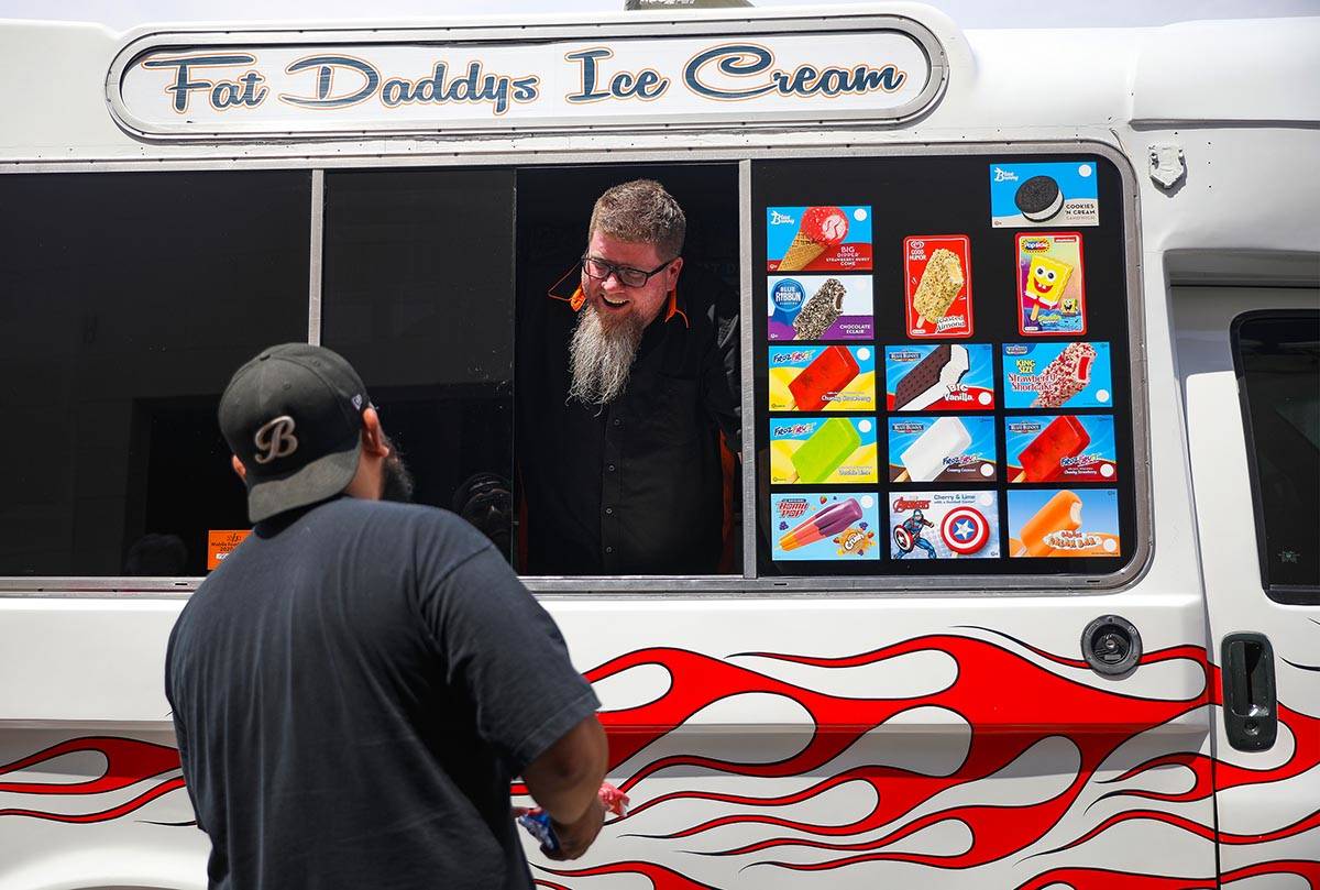 Al Davis, owner of Fat Daddy's Ice Cream truck, sells ice cream to Caliber Collision employees ...