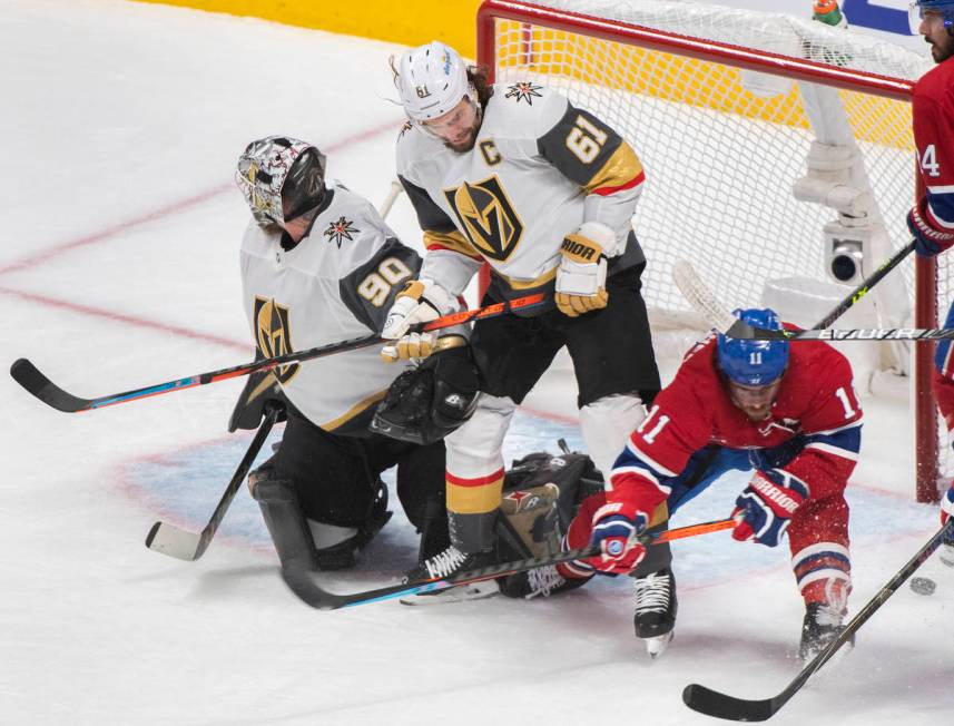 Vegas Golden Knights goaltender Robin Lehner looks on as Knights’ Mark Stone (61) and Mo ...