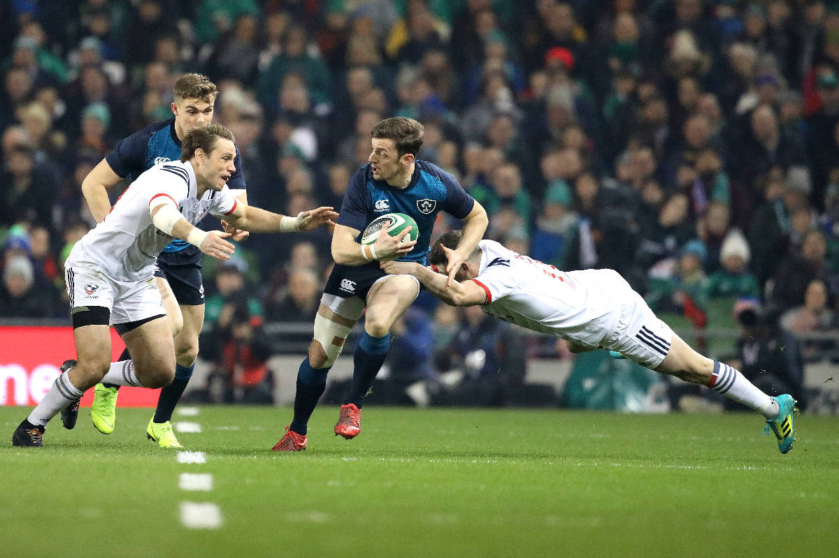 Ireland's Darren Sweetnam, centre, is tackled by USA's Will Magie, right, and Blaine Scully, le ...