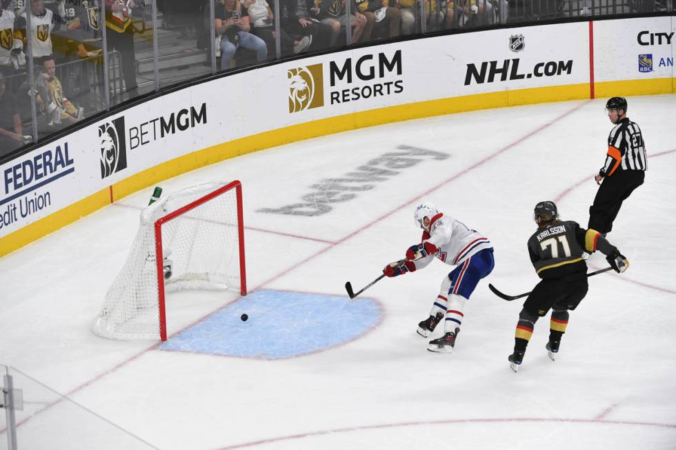 Montreal Canadiens center Nick Suzuki (14) shoots an empty net goal ahead of Vegas Golden Knigh ...