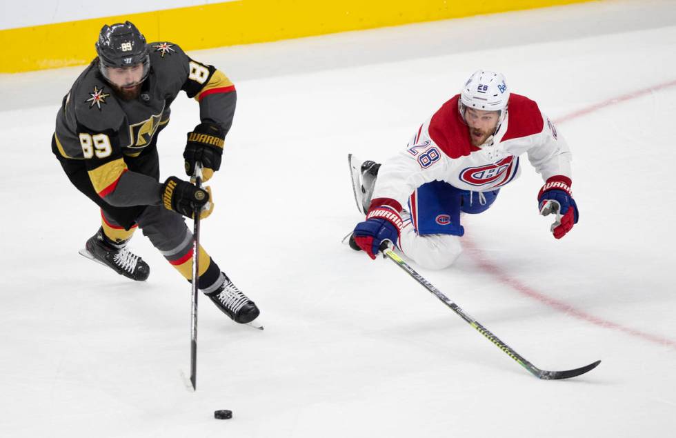 Golden Knights right wing Alex Tuch (89) and Canadiens defenseman Jon Merrill (28) skate for th ...