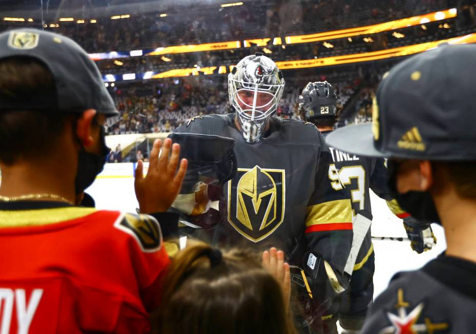 Golden Knights goaltender Robin Lehner (90) greets his kids Lennox, left, and Zoe before the st ...