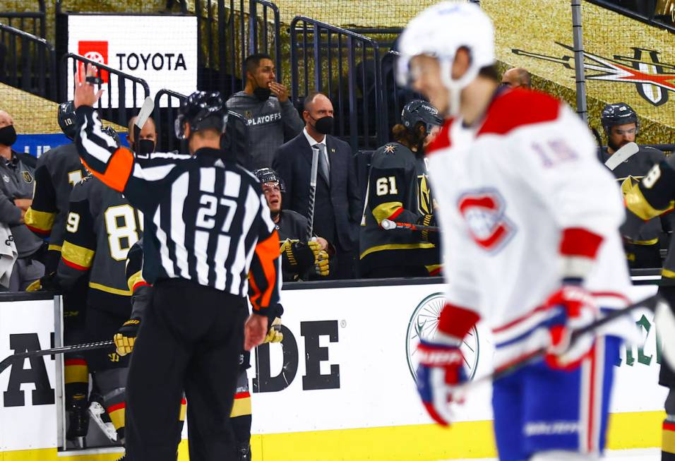 Golden Knights head coach Pete DeBoer, center, looks on during the third period of Game 5 of an ...