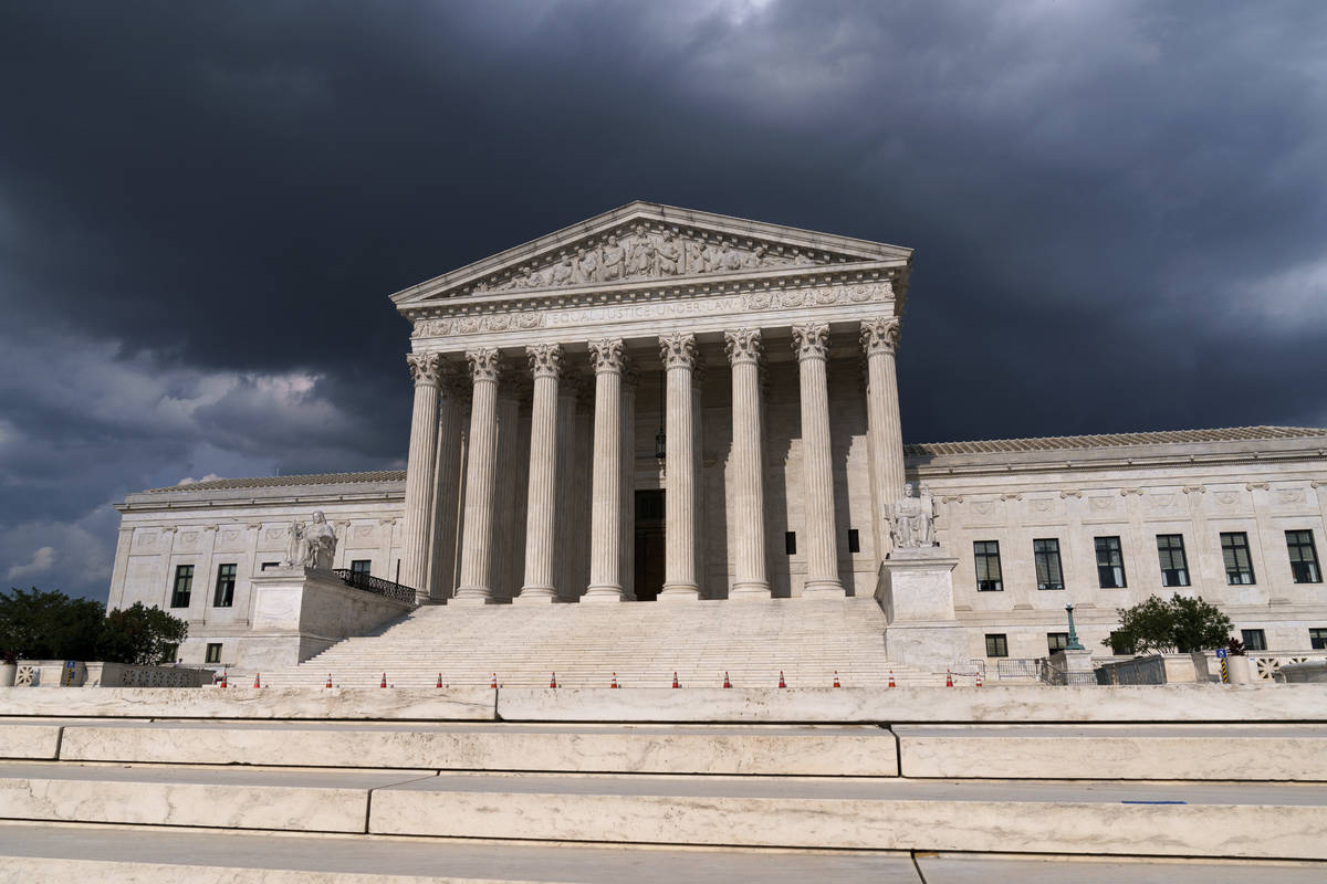 In this June 8, 2021 photo, with dark clouds overhead, the Supreme Court is seen in Washington. ...