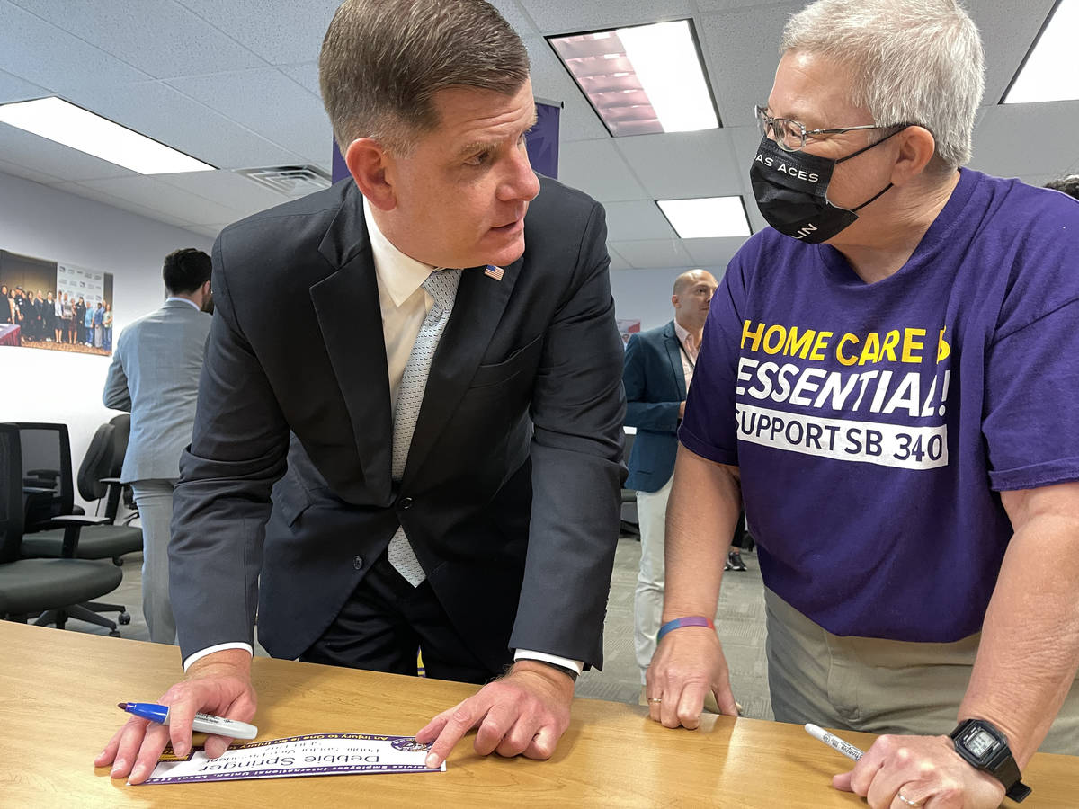 U.S. Secretary of Labor Marty Walsh signs SEIU Local 1107 labor union members name placards, in ...
