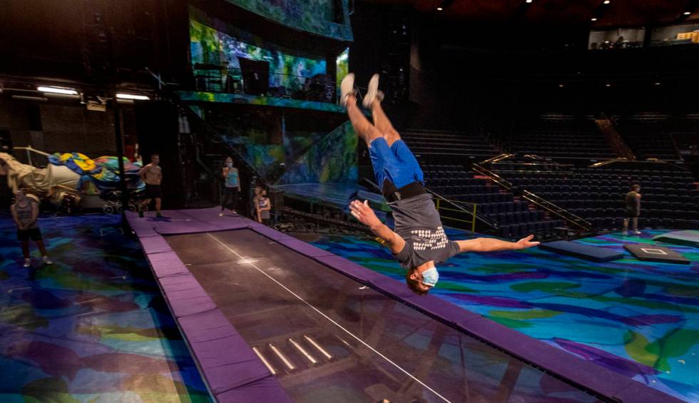 An acrobat practices flips on a power track trampoline during rehearsals for "Mystere,&quo ...