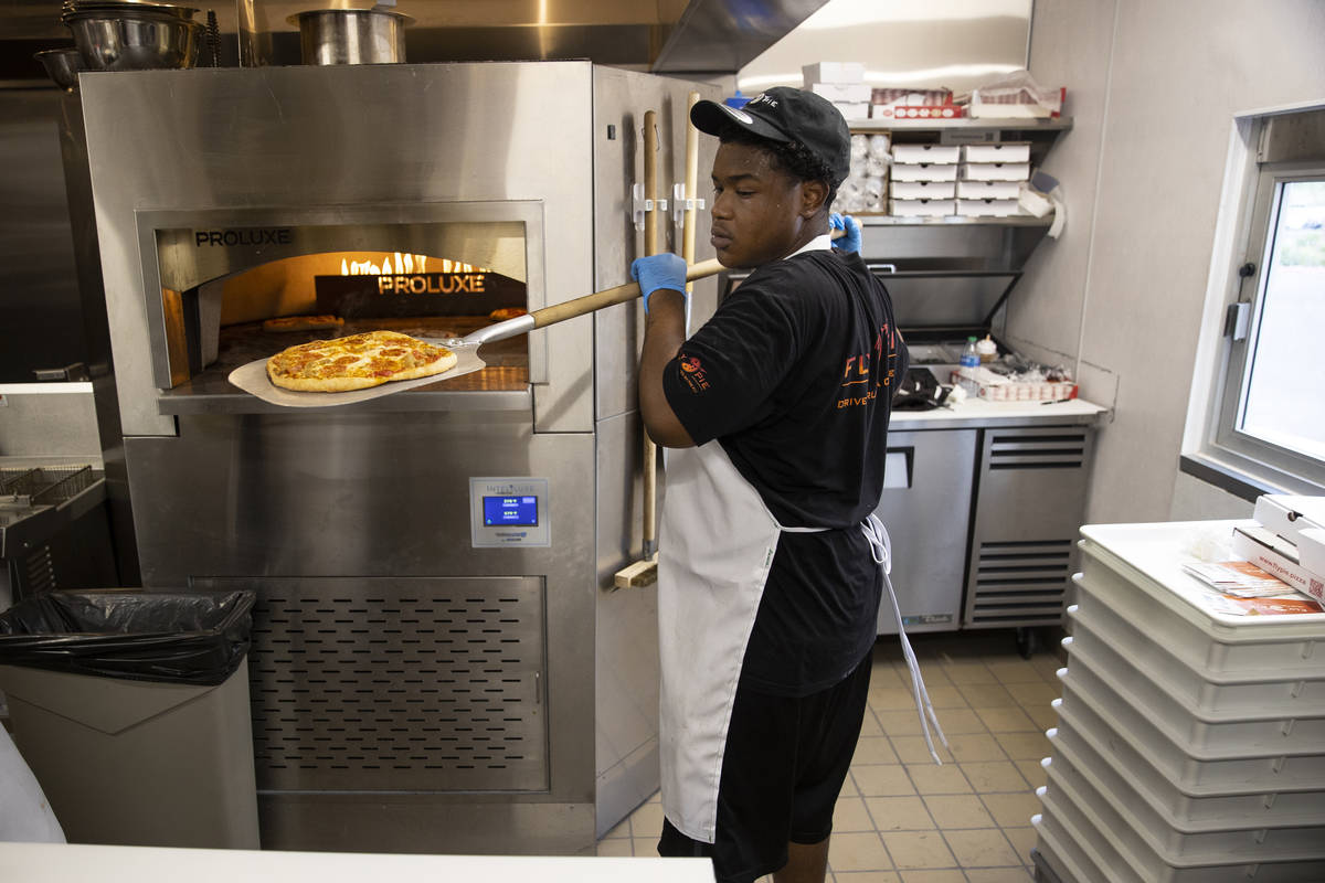 Crew member Derald Williams trains in the kitchen of Fly Pie pizza in Henderson, which opened S ...