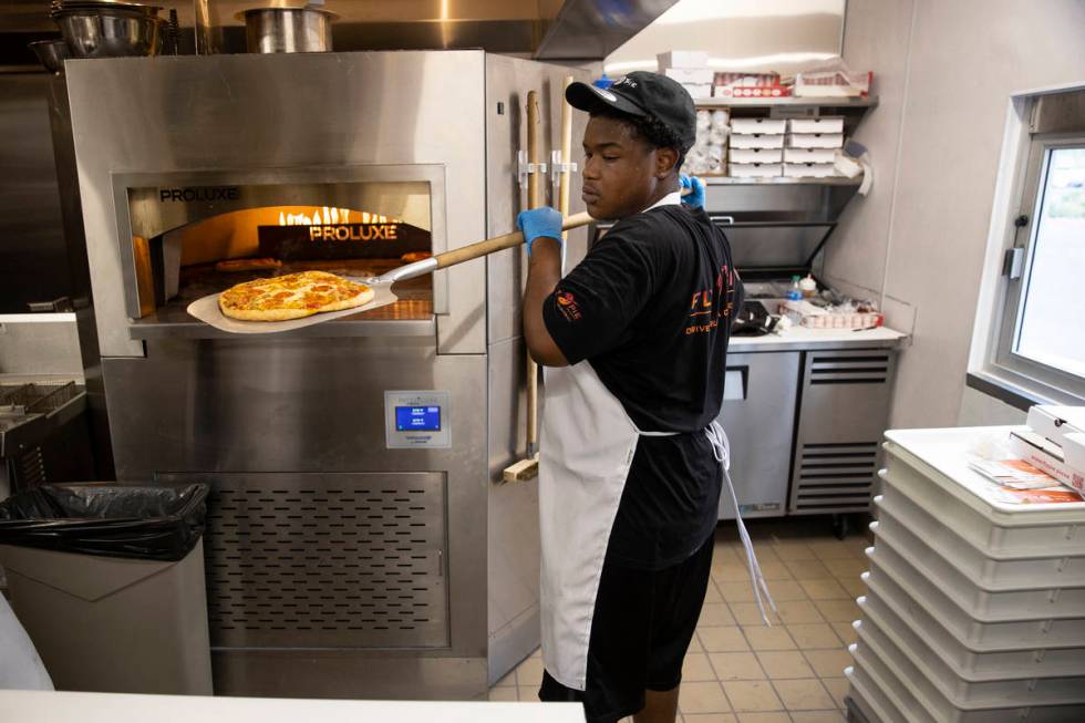 Crew member Derald Williams trains in the kitchen of Fly Pie pizza in Henderson, which opened S ...