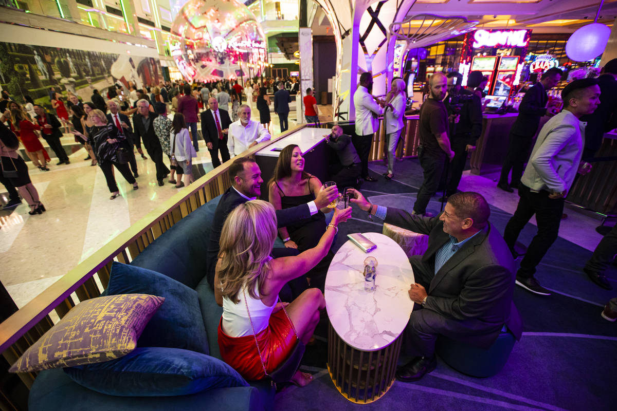 People toast and mingle at GatsbyÕs cocktail lounge during the opening night of Resorts Wo ...