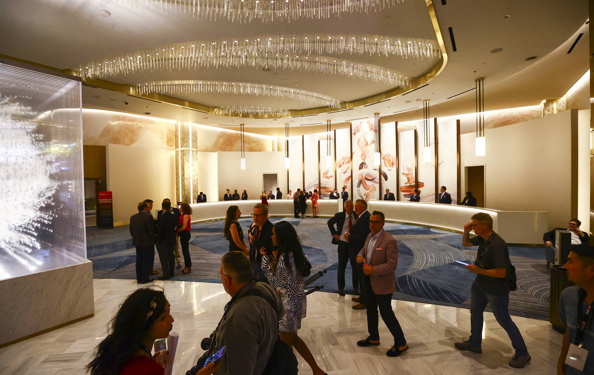 People walk through the Conrad hotel lobby during the opening night of Resorts World Las Vegas ...